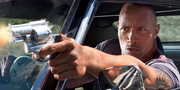 Driver Played By Dwayne Johnson Firing A Gun Out Of His Car Window