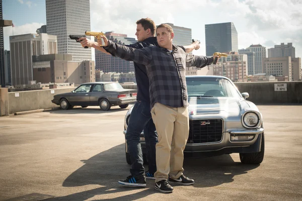 Schmidt and Jenko holding guns